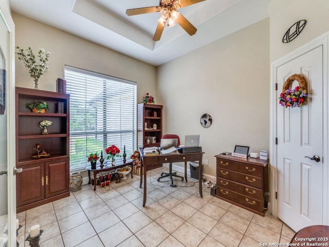 office area featuring light tile patterned flooring, ceiling fan, and baseboards