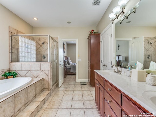 ensuite bathroom featuring a garden tub, a sink, a shower stall, and visible vents