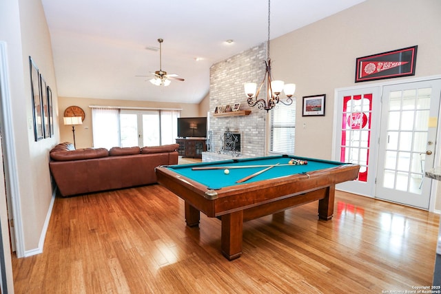 recreation room with lofted ceiling, billiards, light wood finished floors, and ceiling fan with notable chandelier