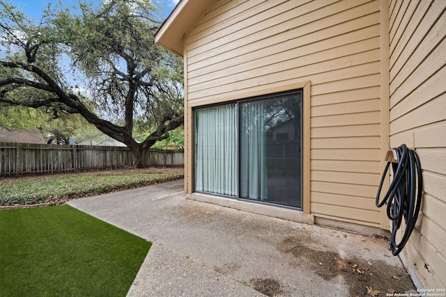 exterior space with fence, a yard, and a patio area