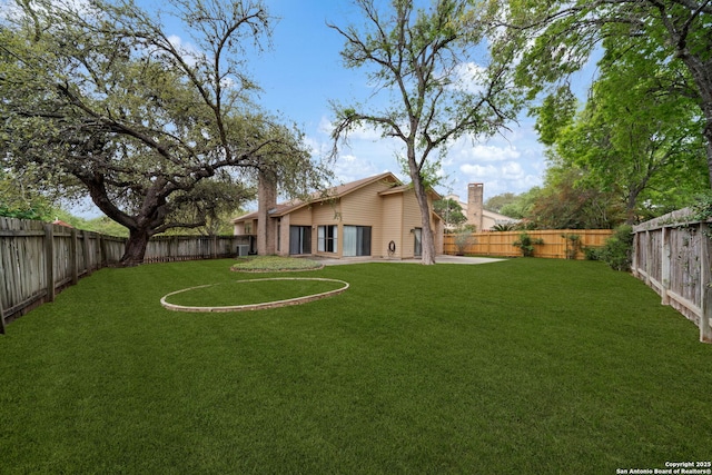view of yard with a fenced backyard