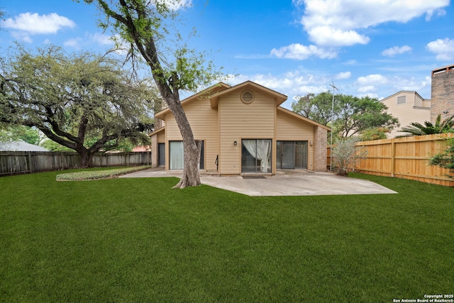 back of property with a lawn, a patio, and a fenced backyard