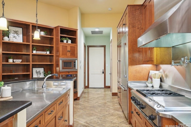 kitchen featuring stainless steel countertops, stainless steel appliances, a sink, visible vents, and wall chimney exhaust hood