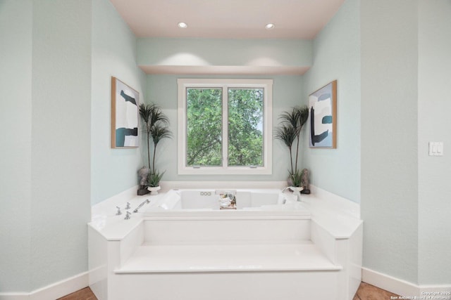 full bathroom with a bath, recessed lighting, and baseboards