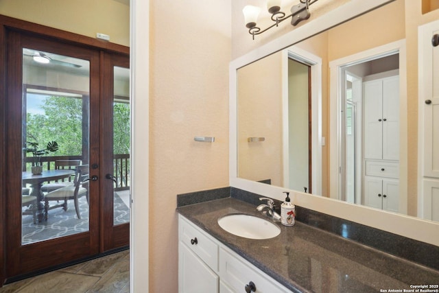 bathroom featuring french doors and vanity
