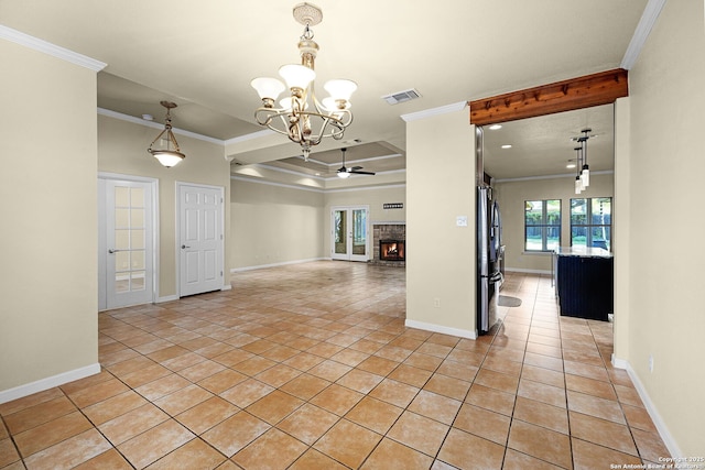 unfurnished room featuring a brick fireplace, light tile patterned floors, visible vents, ornamental molding, and ceiling fan with notable chandelier