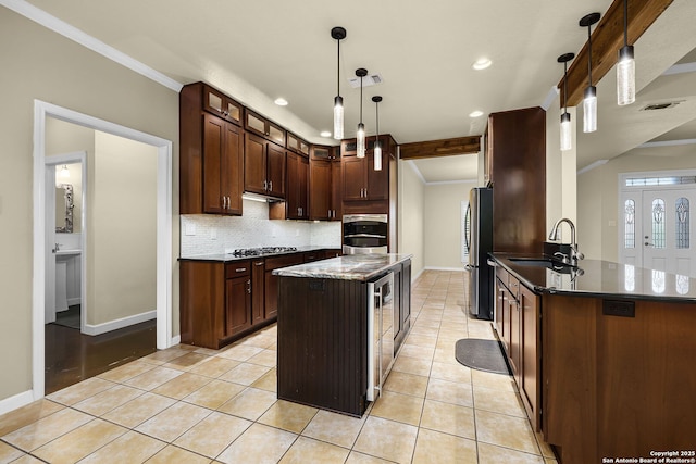 kitchen featuring baseboards, tasteful backsplash, stainless steel appliances, and a sink
