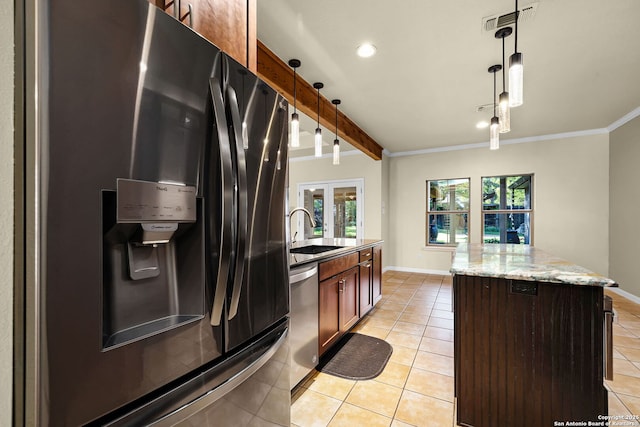 kitchen featuring stainless steel dishwasher, a sink, plenty of natural light, light tile patterned flooring, and fridge with ice dispenser