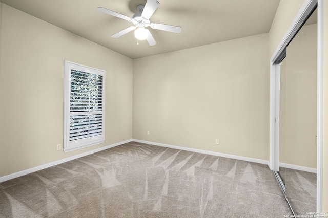 unfurnished bedroom with ceiling fan, a closet, carpet flooring, and baseboards