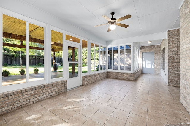 unfurnished sunroom with a ceiling fan