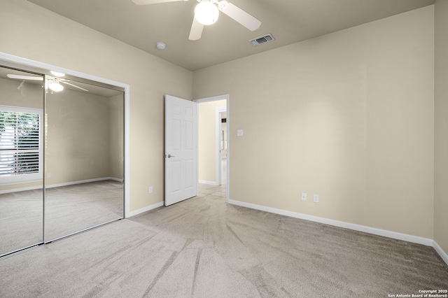 unfurnished bedroom featuring baseboards, visible vents, carpet floors, and a closet