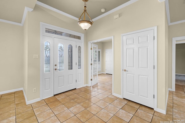 entryway with baseboards, light tile patterned floors, and crown molding