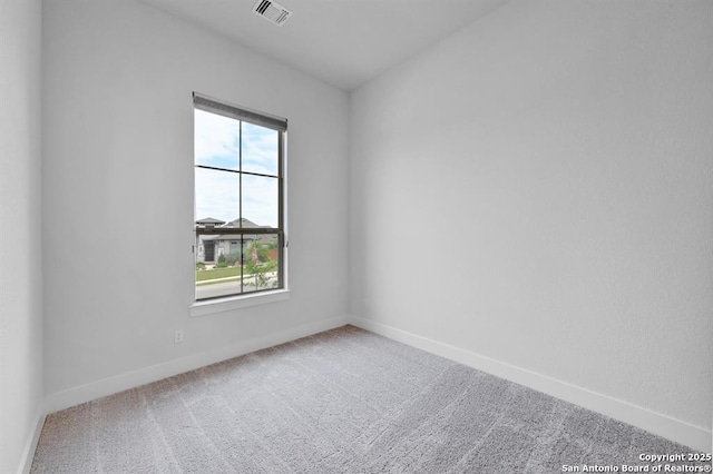 unfurnished room with visible vents, carpet floors, and baseboards
