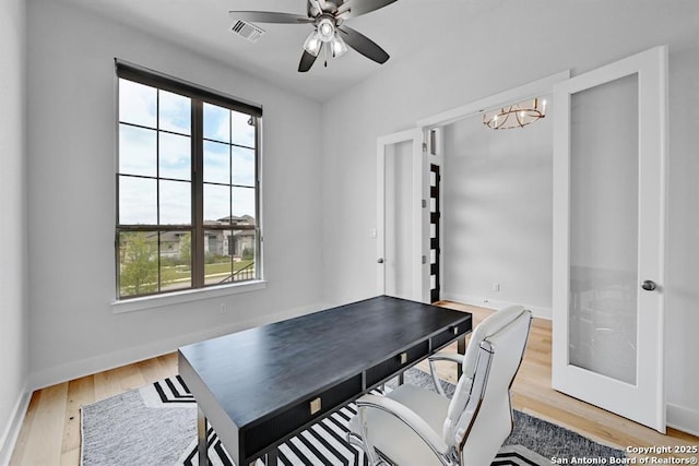 office with visible vents, baseboards, a wealth of natural light, and light wood-type flooring