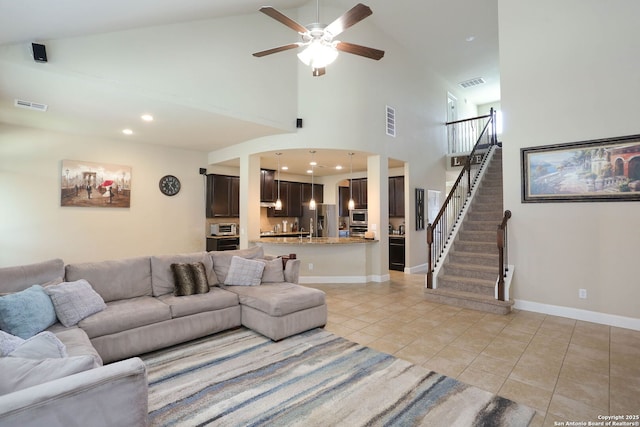 9307 Monument Parke, San Antonio, TX 78254 - living room featuring light tile patterned floors, visible vents, ceiling fan, and stairs