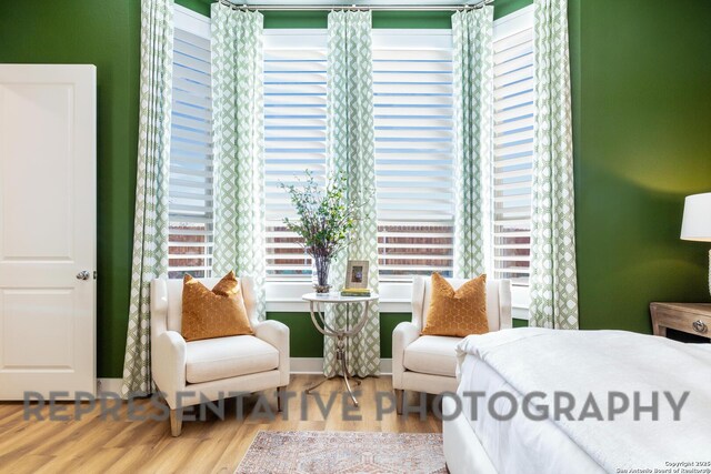 bedroom with wood finished floors and baseboards