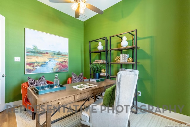 home office with visible vents, ceiling fan, wood finished floors, and baseboards