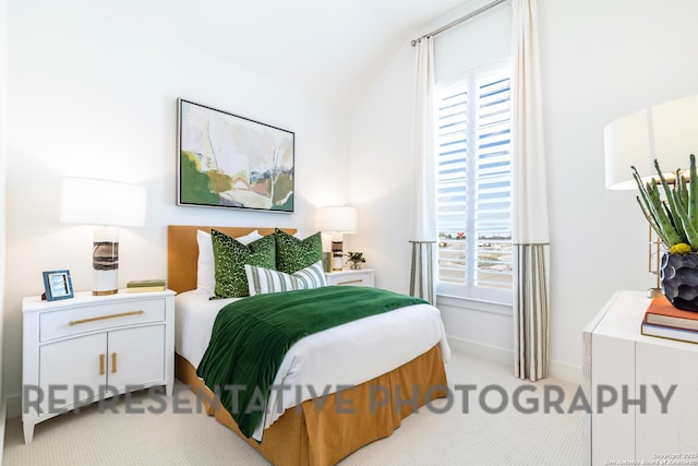 bedroom with light colored carpet, vaulted ceiling, and multiple windows