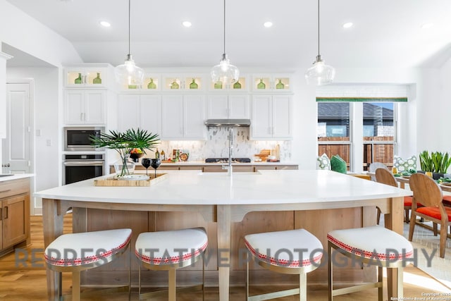 kitchen with recessed lighting, light countertops, stainless steel appliances, and decorative backsplash