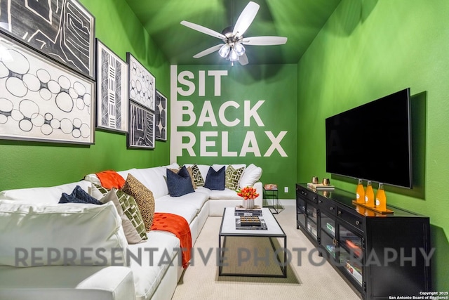 carpeted living area featuring ceiling fan