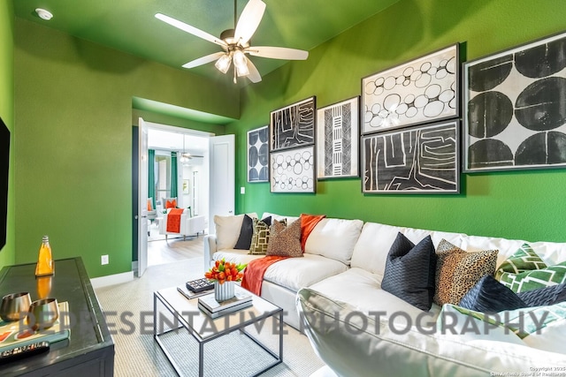 living area with carpet and ceiling fan