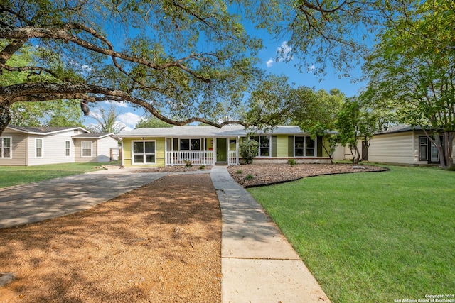 ranch-style home with driveway, a front yard, and a porch