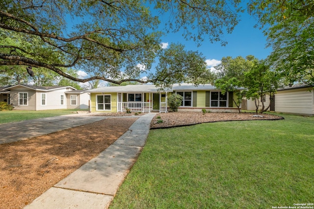 ranch-style house with concrete driveway, a front yard, and covered porch