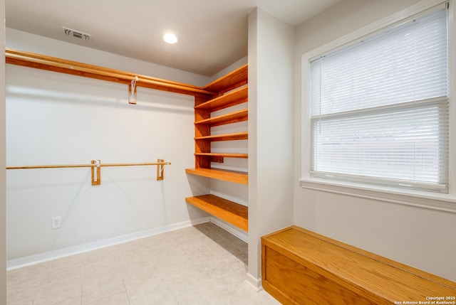 spacious closet featuring light tile patterned floors and visible vents