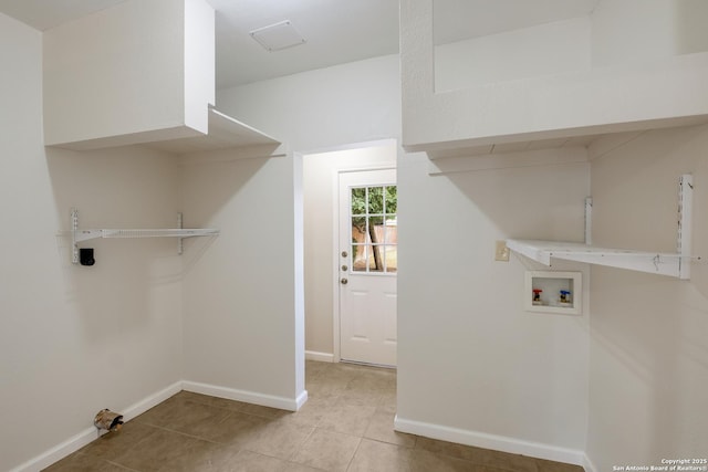 washroom with washer hookup, light tile patterned floors, laundry area, and baseboards