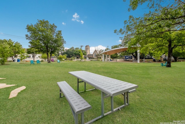 view of property's community with a lawn and a gazebo