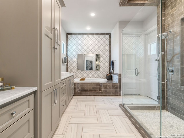 full bath with recessed lighting, a shower stall, a garden tub, and vanity