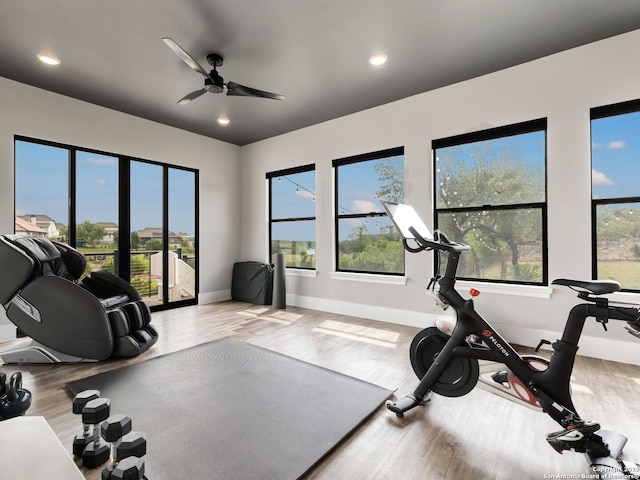 workout room with recessed lighting, wood finished floors, and baseboards