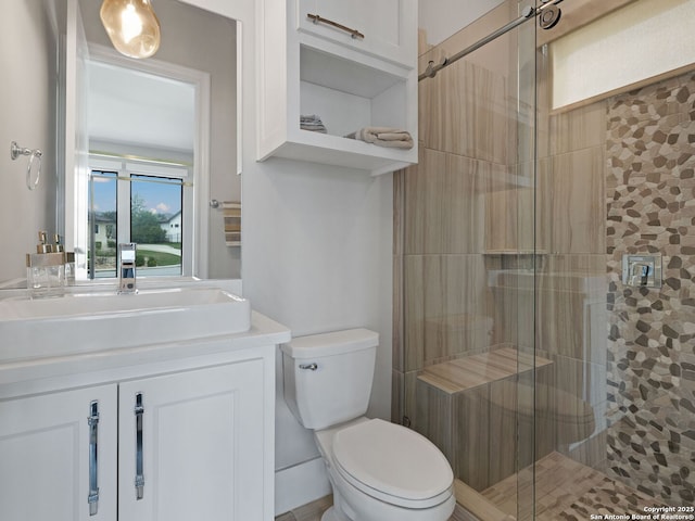 full bath with vanity, toilet, and a stall shower