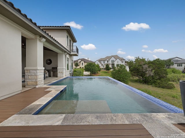 pool featuring a grill and a residential view