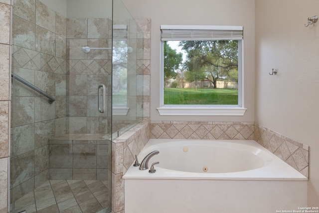 bathroom featuring a stall shower and a bath
