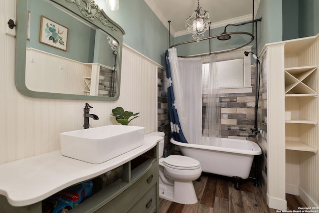 full bathroom featuring wood finished floors, shower / bath combination with curtain, ornamental molding, toilet, and vanity
