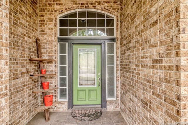 property entrance with brick siding