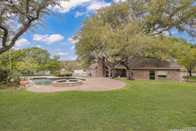 view of yard featuring a fenced backyard, a patio area, an in ground hot tub, and an outdoor pool
