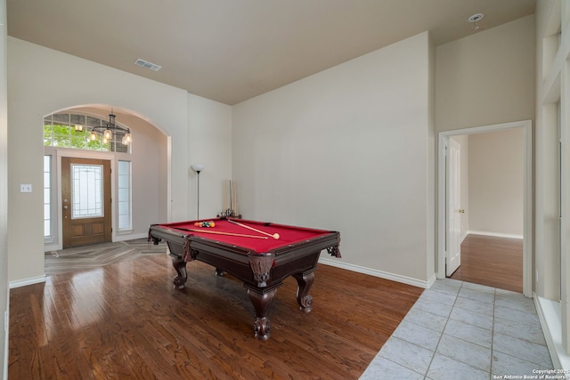 recreation room featuring billiards, visible vents, baseboards, arched walkways, and wood finished floors