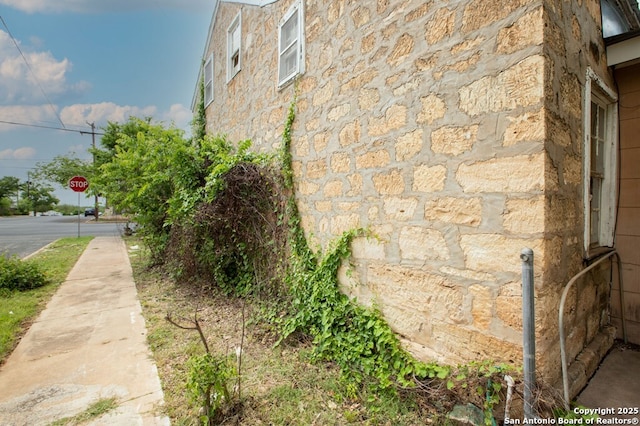 view of side of property featuring stone siding