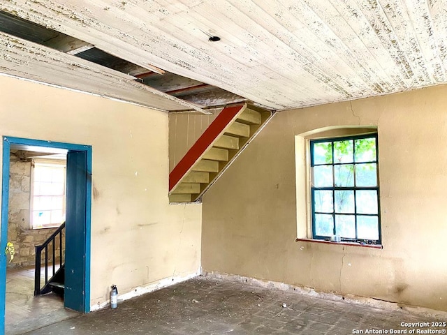 basement with stairs and a healthy amount of sunlight