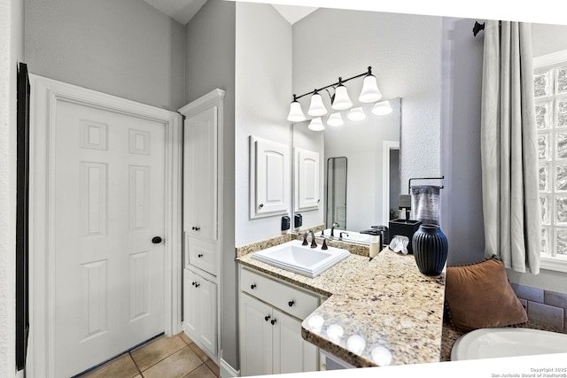 bathroom with tile patterned flooring and vanity