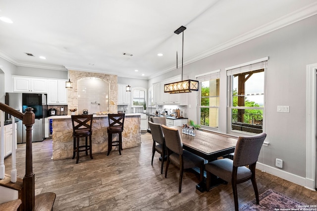 dining room featuring visible vents, dark wood-style flooring, crown molding, and recessed lighting