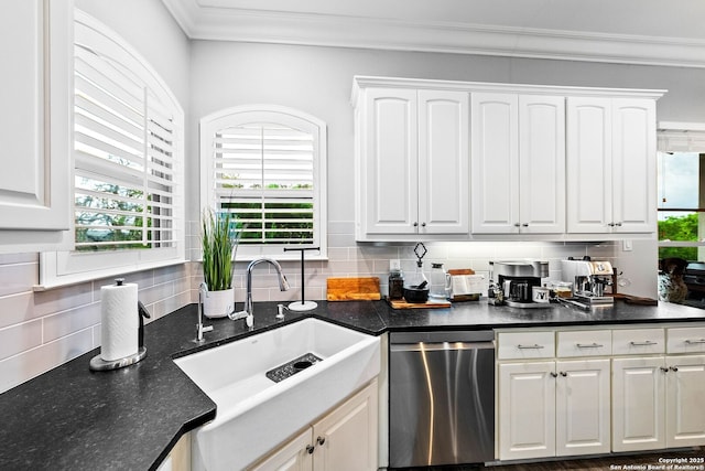kitchen featuring white cabinets, stainless steel dishwasher, crown molding, and a sink