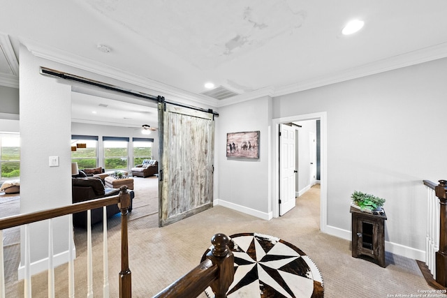interior space with a barn door, baseboards, recessed lighting, ornamental molding, and light carpet