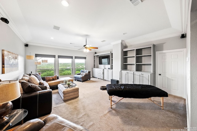 living room featuring visible vents, ornamental molding, ceiling fan, and carpet floors