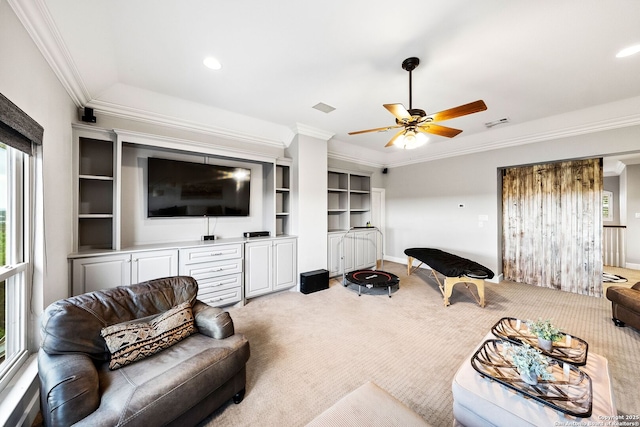 living area featuring visible vents, ornamental molding, ceiling fan, and light colored carpet