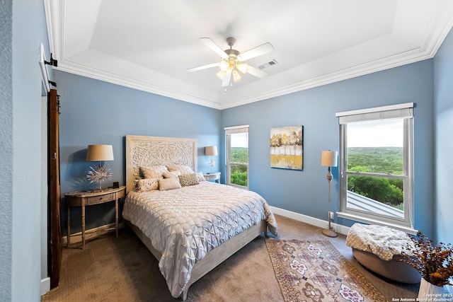 bedroom with a raised ceiling, a ceiling fan, visible vents, baseboards, and carpet floors