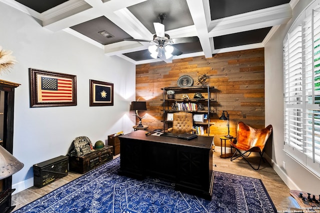 office area with wood walls, wood finished floors, ceiling fan, and plenty of natural light
