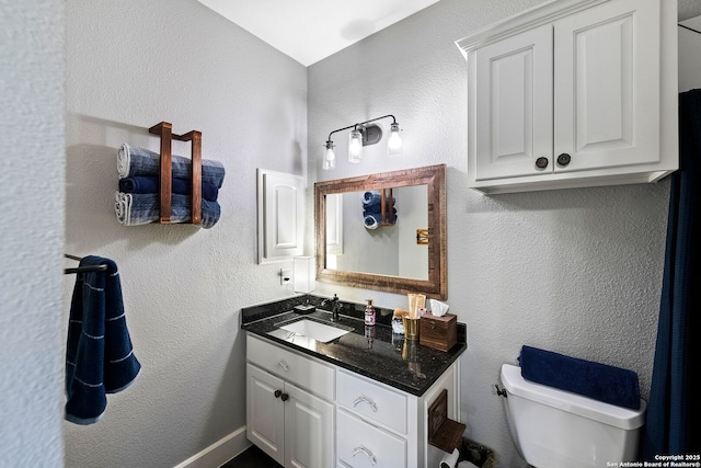 bathroom with toilet and vanity